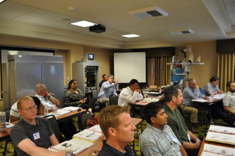 Sean Campbell from Caltrans DRISI raises his hand and asks a speaker a question during the annual Western States Forum.