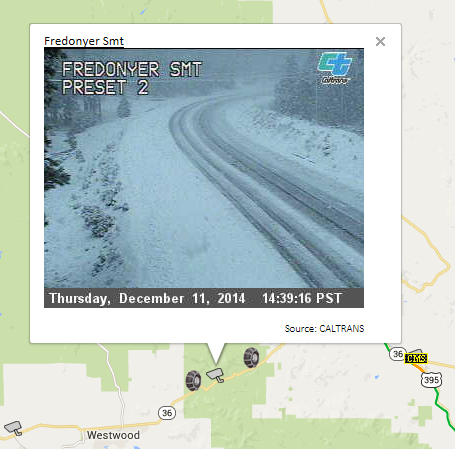 OSS Screenshot, 2014-12-11: CCTV camera image at Fredonyer Summit showing an icy and snow covered roadway.