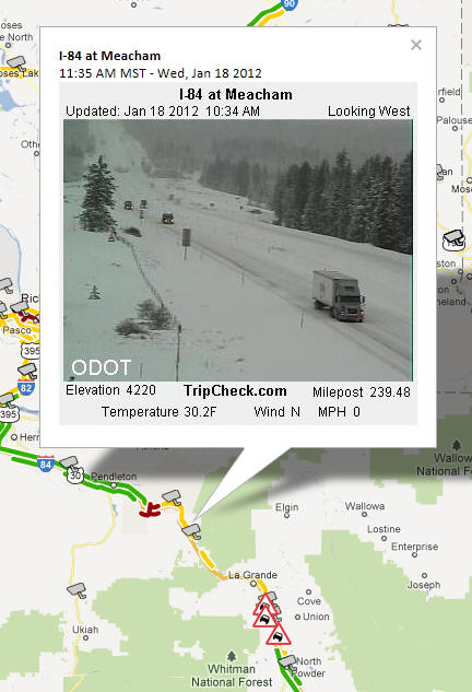 OSS Screenshot (1/18/2012): A CCTV camera image for I-84 at Meacham shows winter driving and poor road conditions.