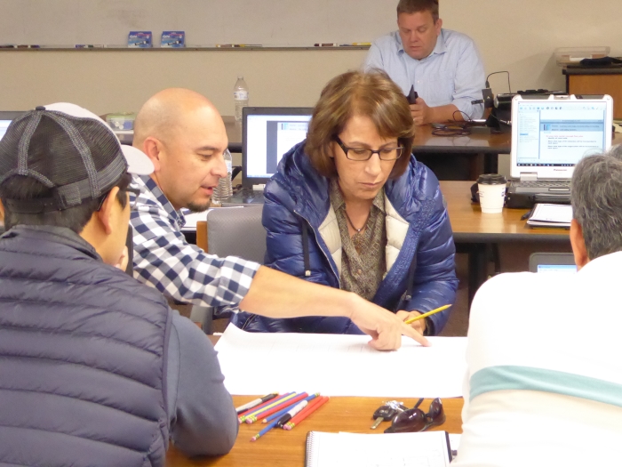 Sam Campos (left) and Shima Afshari (center) from Caltrans District 6 work together with their colleagues from Caltrans District 10 on one of the lab exercises.