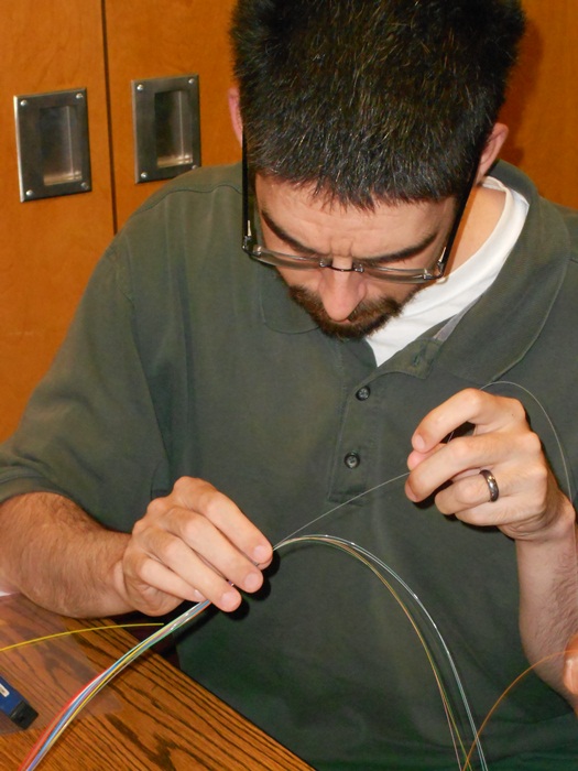 Michael Mullen examines individual fibers in preparation for a troubleshooting exercise.