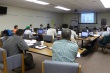 Link, thumbnail, students seated at tables listening to instructor in front of the room