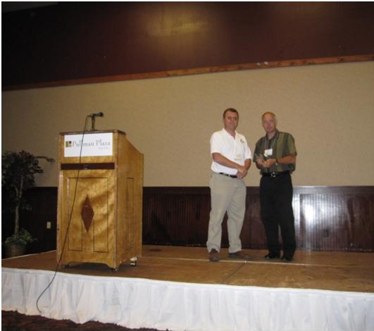 Doug Galarus accepts the 2010 Best of Rural ITS Award from Steve Albert, Rural SIG Chair and Director of the Western Transportation Institute.