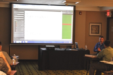Keith Calais, WSDOT, demonstrates the Remote Operating Asset Management (ROAM) system used in the adaptive lighting project.