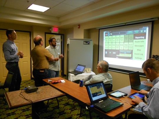 Networking is an integral part of the Forum’s agenda. In this photo, Keith Koeppen (center) explains the Safety Chain Control System components to John Carson of Caltrans District 1 (seated), Lonnie Hobbs from Caltrans District 2 (left), and Tom Moore (center left) from the Nevada DOT. (2015)
