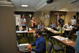 Jeremiah Pearce (front, seated) and Lonnie Hobbs (back, standing), Caltrans District 2, end their presentation with a demonstration during the 2017 Forum.